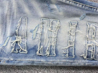 Calça AMIRI Vintage Destroyed Logo Denim (Ice Wash)